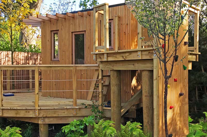 Bespoke contemporary treehouse with zipline tower, rope bridge and climbing wall
