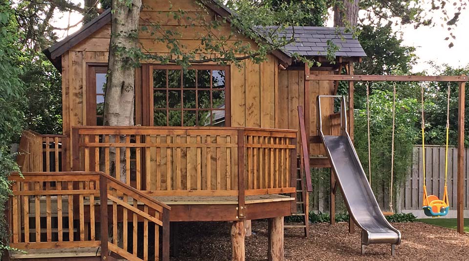 Bespoke treehouse and play tower built under tree canopy